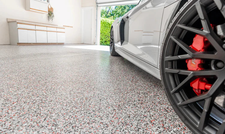Finished flake epoxy garage floor with high-gloss topcoat ready for use in Oxnard, CA